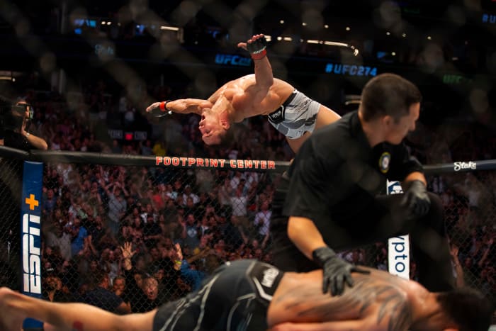 Michael Chandler does a backflip as he celebrates after knocking out Tony Ferguson during UFC 274 at Footprint Center.